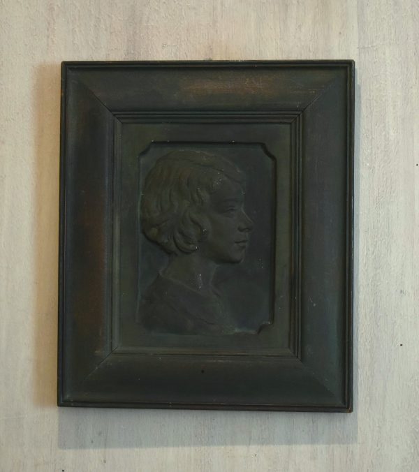 Bronzed plaster portrait relief